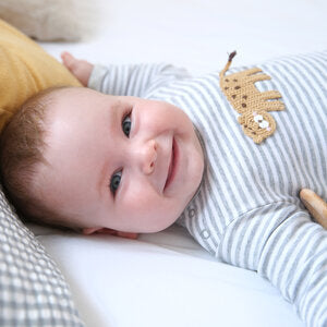 Baby boy wearing striped outfit for Trés Seven baby boy clothing collection