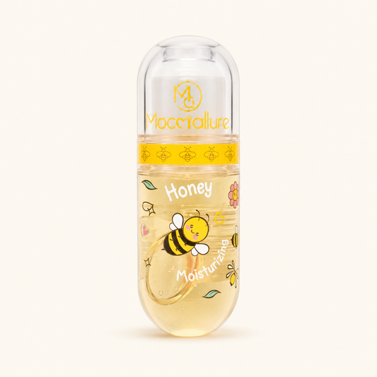 Honey Moisturizing gel cap on a clean off-white background. The clear cap container features a yellow band with bee illustrations and a lower section filled with golden-yellow gel, decorated with a cartoon bee, flowers, and the words 'Honey Moisturizing'.